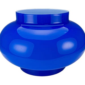 May include: A vibrant blue glass vase with a rounded body and a slightly flared rim. The vase has a glossy finish and a contrasting light blue interior. This decorative piece is suitable for floral arrangements or as a standalone accent.