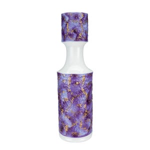 May include: A tall cylindrical vase featuring a smooth white neck and base, with a textured purple and gold leaf finish on the upper rim and the main body. The surface displays a marbled pattern of deep violet and lavender with metallic gold accents.