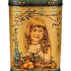 May include: A vintage rectangular tin with a gold background and a portrait of a young girl. The tin has a green and gold border, floral accents, and a still life of fruit and a vase. The tin is likely for storage or display.