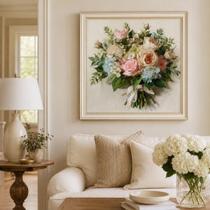 May include: A square framed wall art piece featuring an oil painting of a floral bouquet. The arrangement includes pink and peach roses, light blue hydrangeas, and green foliage, tied with a white ribbon against a textured off-white background.