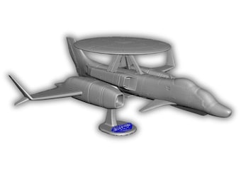 May include: A gray model airplane with a large, circular radar dome on top. The aircraft has two wings and a tail fin. The model is mounted on a stand with a blue base. The overall design is a detailed representation of an airborne early warning aircraft.