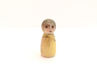 Tiny wood woman in primrose yellow