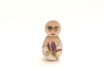 Tiny wood person with iris bloom