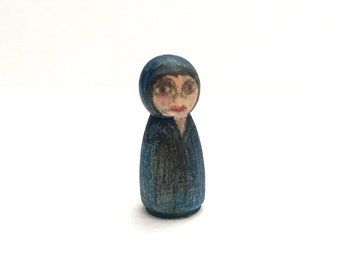 Tiny wood cloaked figure