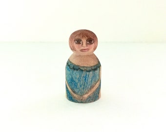 Tiny wood woman in blue bathing suit