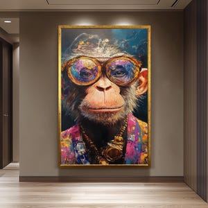May include: A framed portrait of a monkey wearing large, round, gold-rimmed glasses. The monkey is adorned with a gold necklace and a colorful patterned jacket. The artwork has a gold frame and is displayed on a wall.
