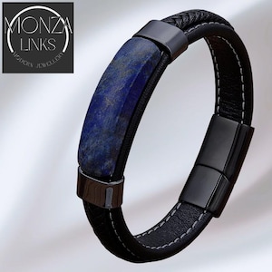 Könnte beinhalten: Ein schwarzes Lederarmband mit blauem Steineinsatz und schwarzen Metallverschlüssen. Das Armband hat weiße Nähte und einen geflochtenen Lederabschnitt. Der Text "MONZA LINKS MODERN JEWELLERY" ist im Bild enthalten.