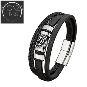 May include: Black leather bracelet with a silver lion head charm and a silver clasp. The bracelet is made of three strands of leather.
