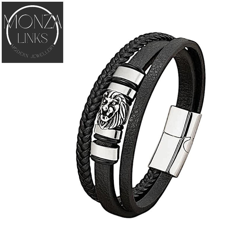 May include: Black leather bracelet with a silver lion head charm and a silver clasp. The bracelet is made of three strands of leather.