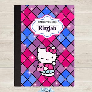 May include: A composition book featuring a diamond pattern in shades of pink, purple, and blue with sparkling star accents. A white label in the center displays the text COMPOSITION BOOK and the name Elayjah. Hello Kitty is pictured below.