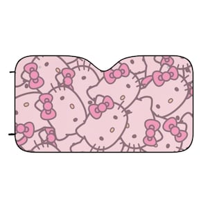 Può includere: Parasole per auto rosa con un motivo ripetuto di volti di Hello Kitty. Il parasole è realizzato in un materiale leggero ed è progettato per bloccare i raggi del sole.