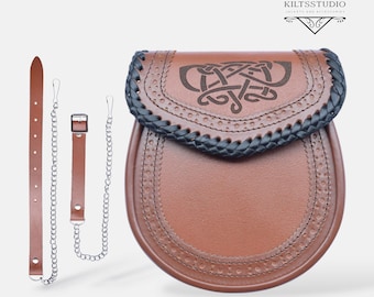 May include: A brown leather sporran with a Celtic knot design on the flap. The flap has a black braided edge. Includes a brown leather strap and chain. The sporran is a traditional Scottish accessory.