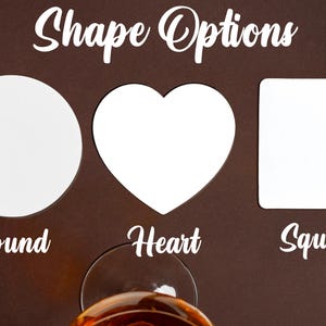 May include: White coasters in round, heart, and square shapes are shown against a brown background. The text "Shape Options" is at the top, with "Round", "Heart", and "Square" below each shape. A glass of amber liquid is at the bottom.