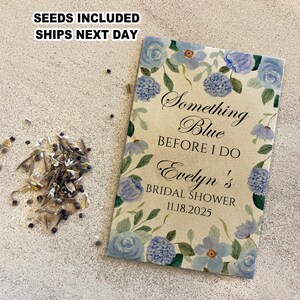May include: A light blue and brown card with watercolor flowers and the text "Something Blue Before I Do Evelyn's Bridal Shower 11.18.2025"