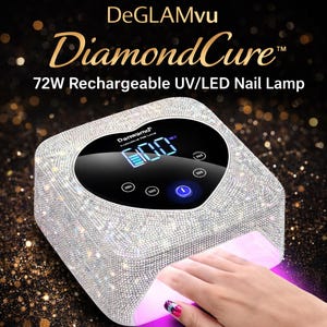 May include: A square, silver nail lamp with a rhinestone-covered exterior. The lamp has a digital display showing a timer and a blue power button. The text "DeGLAMvu DiamondCure" and "72W Rechargeable UV/LED Nail Lamp" are visible.