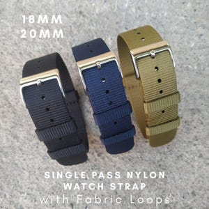 May include: Three single-pass nylon watch straps in black, navy blue, and olive green. Each strap has a silver-colored buckle and fabric loops. The text on the image reads "18MM 20MM" and "SINGLE PASS NYLON WATCH STRAP with Fabric Loops."