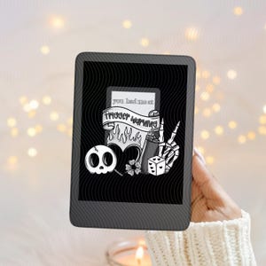 Puede incluir: Ilustración en blanco y negro en una tableta. La imagen presenta una calavera, un corazón, una flor, un encendedor, un dado y una mano de esqueleto. El texto en la imagen dice "you had me at trigger warning."