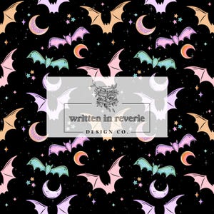 May include: A repeating pattern on a black background featuring bats, crescent moons, and stars in pastel colors. The bats are in shades of pink, peach, and teal. The text "written in reverie DESIGN CO." is in a white rectangle.