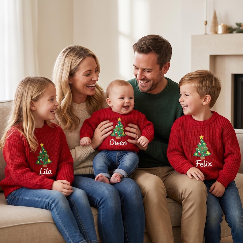 May include: Matching red knit sweaters featuring a graphic of a decorated Christmas tree and personalized names. The sweaters are worn by three children, with the names Lila, Owen, and Felix embroidered in white script below the tree design.