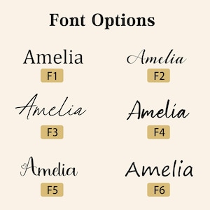 May include: Image showcasing six different font options for the name "Amelia." Each font style is displayed with the name and a corresponding label (F1-F6) on a light beige background. The text "Font Options" is at the top.