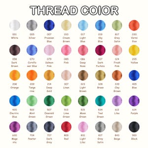 May include: A color chart titled THREAD COLOR featuring forty-eight circular swatches of embroidery thread in various shades including white, silver, blue, brown, pink, yellow, orange, green, purple, red, and black, each labeled with a number and name.