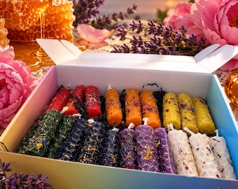May include: A rectangular cardboard box containing an assortment of cylindrical beeswax candles with a honeycomb texture. The candles are arranged in rows and feature various colors including red, orange, yellow, green, blue, purple, and white.