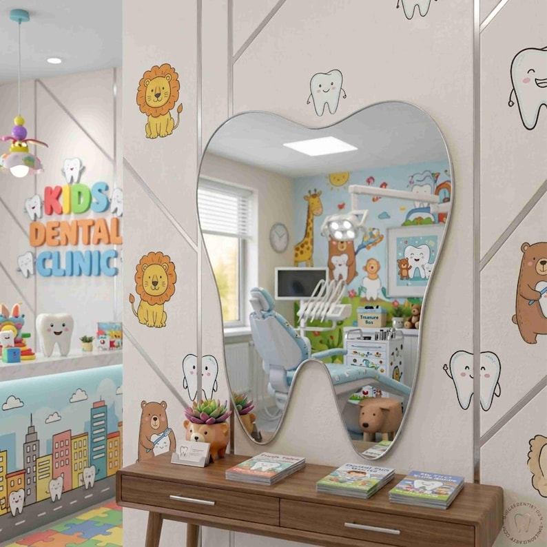 May include: A tooth-shaped wall mirror mounted above a wooden console table. The mirror reflects a pediatric dental office with a dental chair, medical equipment, and colorful wall decals of cartoon animals and teeth in a bright room.