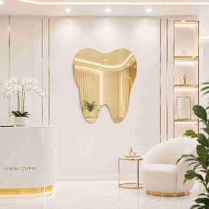 May include: A tooth-shaped wall mirror with a reflective surface, mounted on a white wall. The mirror features a smooth, curved outline resembling a molar, providing a clear reflection of the interior space and a potted plant within the room.