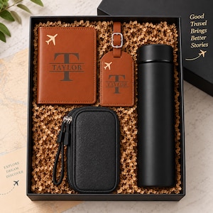 May include: A gift set in a black box containing a tan leather passport holder and luggage tag, both featuring an airplane icon and the name Taylor, a black zippered tech organizer case, and a matte black cylindrical insulated water bottle.