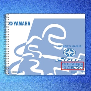 May include: A spiral-bound Yamaha owner's manual with a white and light blue cover featuring a stylized graphic, the Yamaha logo, the text Star, and the model numbers XV19CSX(C) and XV19CX(C) printed in the lower right corner with code LIT-11626-21-26.