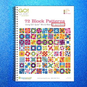 May include: A spiral-bound book titled "72 Block Patterns" featuring colorful quilt block designs. The cover text includes "GO! Qube" and "8" Quilt Block." The book's cover displays a grid of various quilt block patterns in vibrant colors.