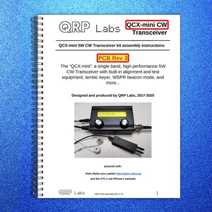 May include: A spiral-bound manual titled "QCX-mini 5W CW Transceiver kit assembly instructions." The cover features the QRP Labs logo and text. The manual includes a photo of the transceiver, earbuds, and a paddle. The text "PCB Rev 3" is also visible.