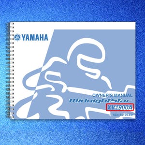 May include: A spiral-bound Yamaha owner's manual for the Midnight Star XV1900A motorcycle. The cover features a light blue and white graphic design with the Yamaha logo, the text Owner's Manual, Midnight Star, XV1900A, and 5C4-28199-E0.