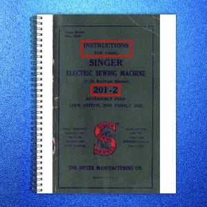 May include: A vintage instruction manual for a Singer electric sewing machine. The cover is dark green with white text that reads "Instructions for Using Singer Electric Sewing Machine 201-2". The manual is spiral-bound.