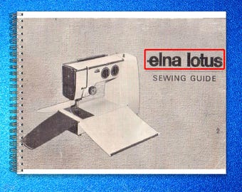 May include: A spiral-bound instructional manual titled elna lotus SEWING GUIDE, featuring a black and white illustration of a sewing machine on a textured gray cover. The cover includes the number 2 in the bottom right corner and a red box.