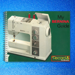 May include: A white Bernina sewing machine with a green cover and the text "My BERNINA Guide." The cover also features the text "Record 930 Electronic." Two red spools of thread are visible.