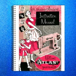 May include: A spiral-bound instruction manual with a vintage illustration. The cover features a pink sewing machine, a woman, and a girl holding a doll. Text includes "for sewing pleasure" and "Instruction Manual". The Atlas Deluxe guarantee is also visible.