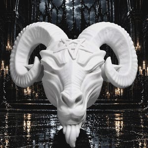 May include: A matte white sculpture of a ram head featuring large, curved, textured horns and a prominent pentagram symbol centered on the forehead. The ram has closed eyes, a defined snout, and a small beard, presented as a singular wall-mounted piece.