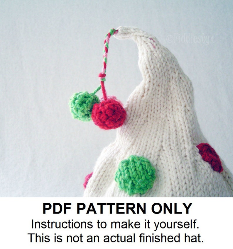 May include: A white knitted hat with red and green pom-poms and a red and white yarn tail. The hat has a pointed top and is decorated with green and red polka dots. PDF PATTERN ONLY. Instructions to make it yourself. This is not an actual finished hat.
