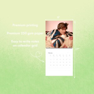 May include: A wall calendar featuring a person wearing a blue and white striped sweater. The calendar is 8 inches wide and 17 inches tall. The text on the calendar reads "February". The calendar is printed on premium 250 gsm paper.