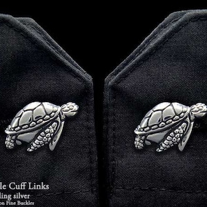 May include: Sterling silver sea turtle cuff links. The cuff links are detailed with a realistic sea turtle design.