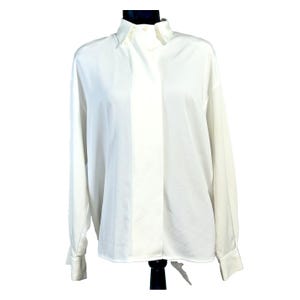May include: A white long-sleeved shirt with a classic collar. The shirt is made of a smooth fabric, possibly silk. The cuffs are buttoned, and the shirt is displayed on a black mannequin.