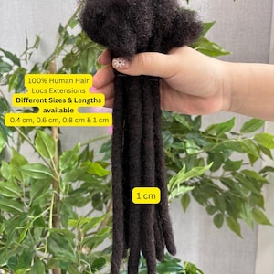 May include: A bundle of dark brown locs extensions made of 100% human hair. The extensions are available in different sizes and lengths, including 0.4 cm, 0.6 cm, 0.8 cm, and 1 cm. The image includes text that says "100% Human Hair Locs Extensions Different Sizes & Lengths available 0.4 cm, 0.6 cm, 0.8 cm & 1 cm".