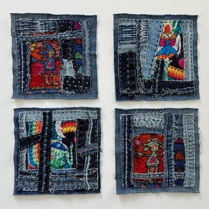 May include: Four square textile art pieces. Each piece is a patchwork of denim with colorful fabric inserts. The inserts feature abstract designs and figures in red, blue, and other vibrant colors. The edges are frayed.