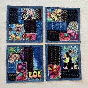 May include: Four denim-framed squares with colorful patchwork fabric inside. Each square features a different design, including peace signs, flowers, and a silhouette of a person. The squares are stitched together with colorful thread.