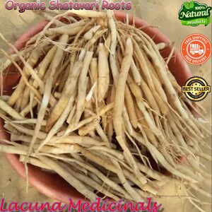 May include: A collection of light beige organic Shatavari roots in a reddish-brown bowl. The image features the text "Organic Shatavari Roots" and "Lacuna Medicinals". There is also a "100% Natural products" logo and a "Best Seller" badge.