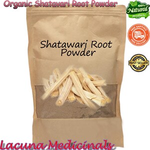 May include: A brown paper bag of Shatavari Root Powder. The bag has a clear window displaying the powder and root pieces. The text on the bag reads "Shatavari Root Powder" and "Organic Shatavari Root Powder".
