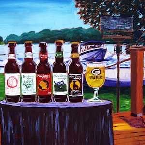 May include: Five bottles of New Glarus Brewing Company beer on a black table with a glass of beer that says "Packers" on it. The bottles are in front of a lake scene with a boat and a person waterskiing.