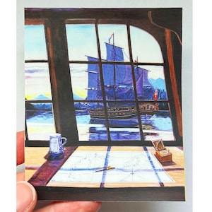 May include: An artistic rendering of a ship sailing on the water, viewed through a window. A map and a small box sit on a table in the foreground. A small blue and white mug is also on the table. The ship has blue sails and a red flag.