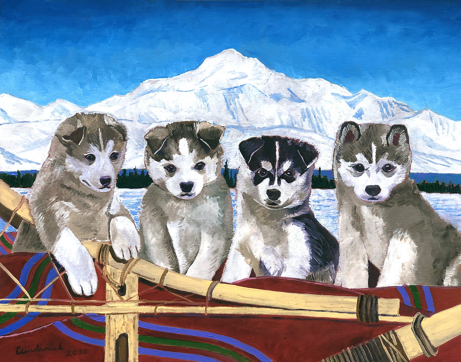 デナリ山の前で犬ぞりに乗るアラスカン・ハスキーの子犬たち。アラスカ